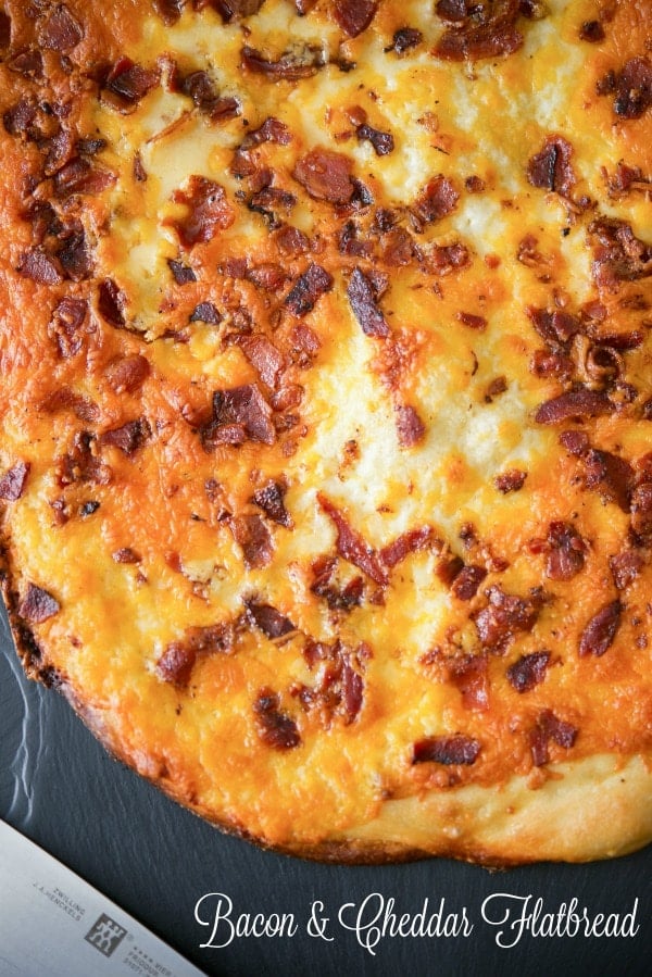 A close up bacon cheddar flatbread pizza