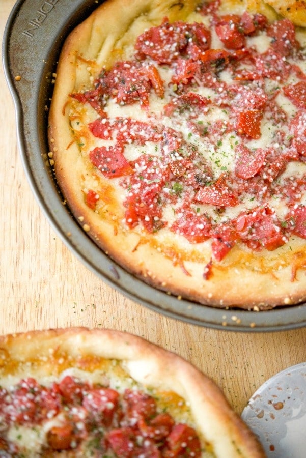 A pizza sitting on top of a wooden table