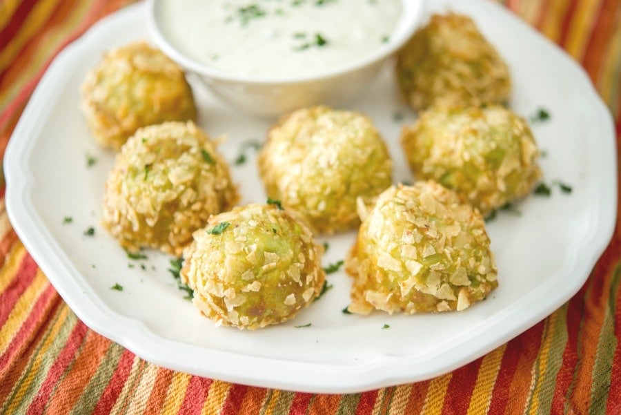 A plate of food Guacamole bites 