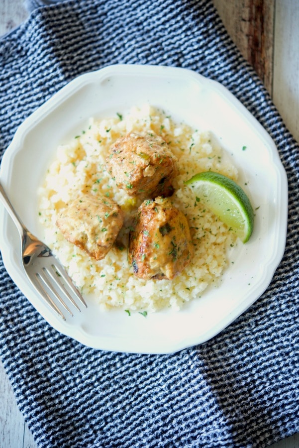 Coconut Lime Chicken Meatballs on a plate with a lime. 