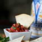 Homemade Tortilla Chips dipped into pico de gallo.