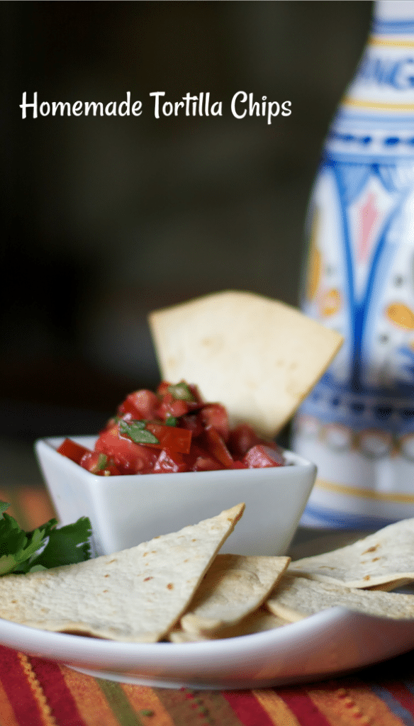 Homemade Tortilla Chips dipped into pico de gallo.