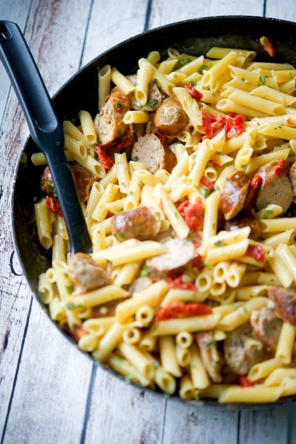 Pasta with Sun Dried Tomato Basil Cream Sauce in a skillet.