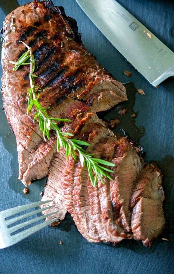 Beef London broil marinated in red wine, garlic, rosemary, balsamic vinegar and light olive oil; then grilled to your liking. 