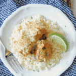 Coconut Lime Ground Chicken Meatballs on a white plate with rice and a lime wedge.