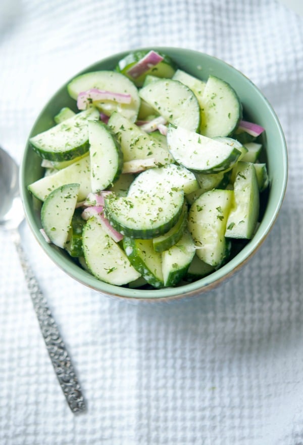 Asian Cucumber Salad in a bowl on a white napkin.