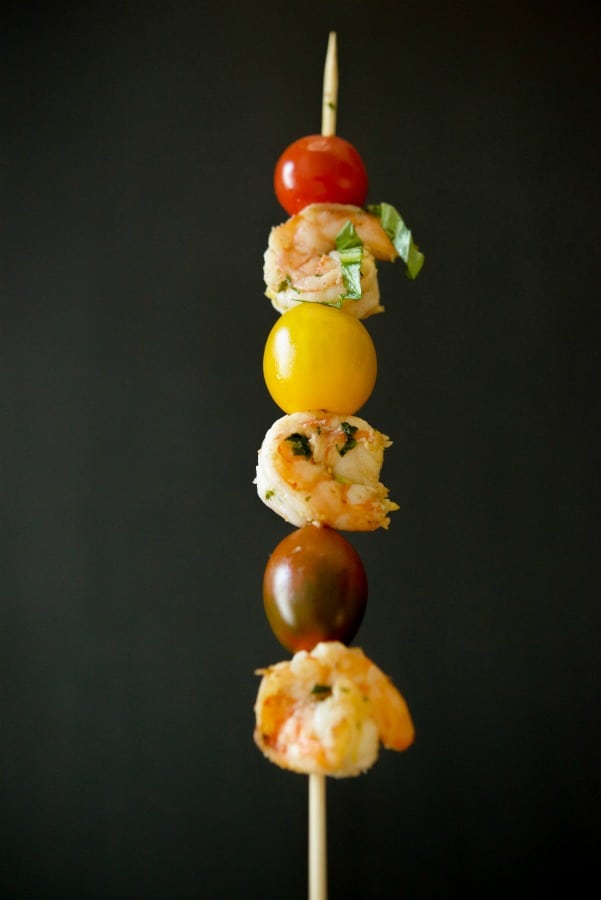 Lemon Basil Grilled Shrimp on a skewer with cherry tomatoes. 