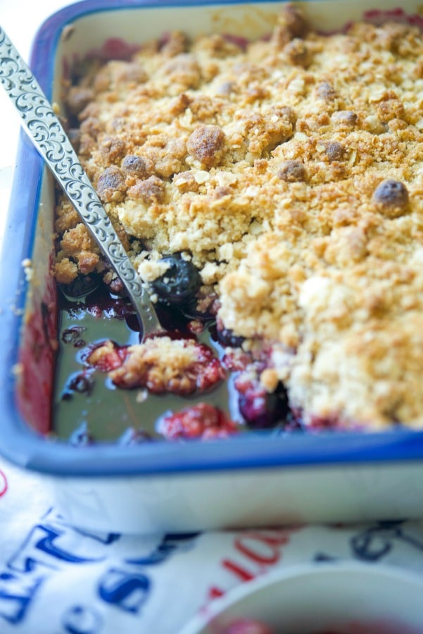 A close up of Blueberry Crisp with a spoon