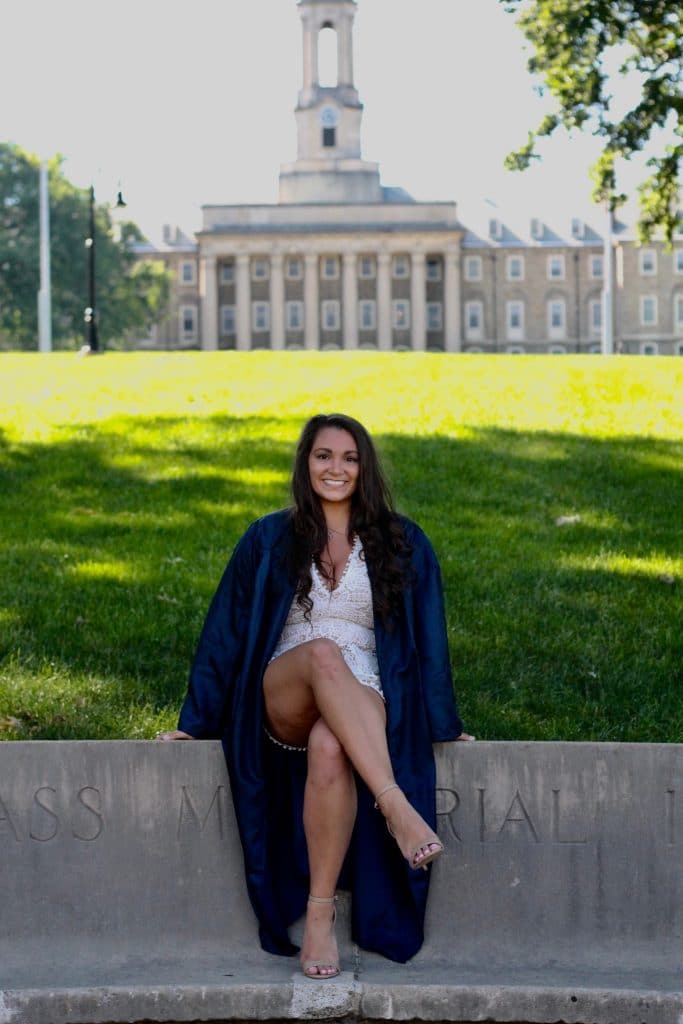 A woman sitting on a bench posing for the camera