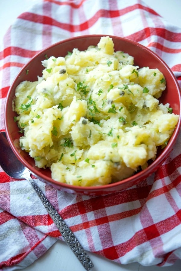 Lemon Caper Vinaigrette Potato Salad in a red bowl. 