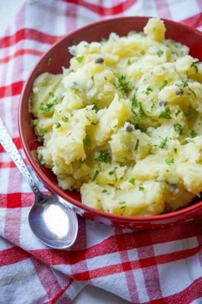 Lemon Caper Vinaigrette Potato Salad in a red bowl.