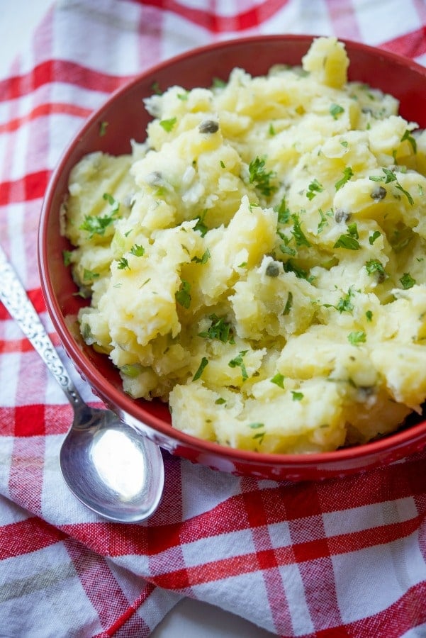 Lemon Caper Vinaigrette Potato Salad in a red bowl.