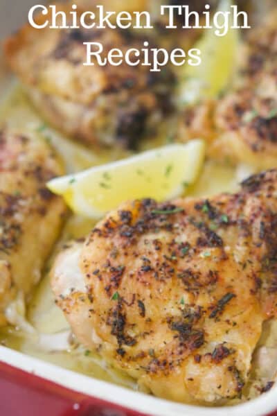A close up of chicken thighs with lemon.
