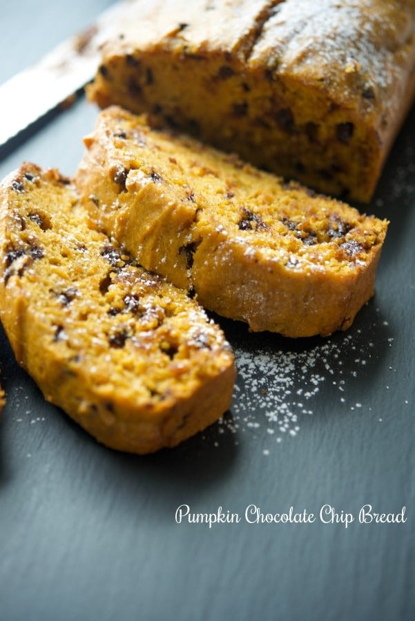 Pumpkin Chocolate Chip Bread sliced on a slate board. 