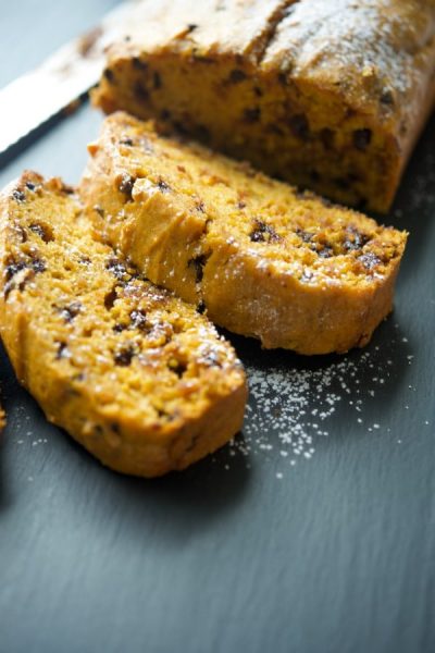 Pumpkin Chocolate Chip Bread sliced on a slate board.