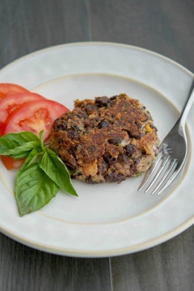 Caprese Black Bean Burgers on a plate with a fork.