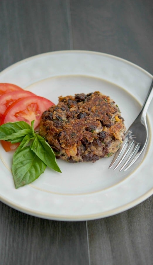 Caprese Black Bean Burgers on a plate with a fork. 