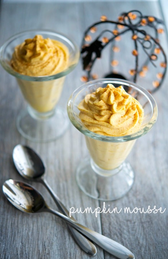 Pumpkin Mousse in a glass dish with a spoon.