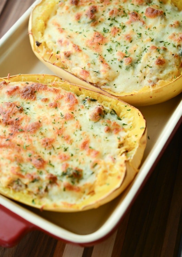 Italian Stuffed Spaghetti Squash made with sweet Italian sausage, fresh spinach, garlic, and fire roasted tomatoes topped with shredded Mozzarella cheese.