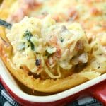 Italian Stuffed Spaghetti Squash made with sweet Italian sausage, fresh spinach, garlic, and fire roasted tomatoes topped with shredded Mozzarella cheese.