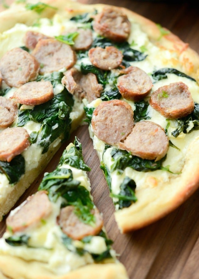 Sausage & Spinach White Deep Dish Pizza made with part skim Ricotta and Mozzarella cheeses, fresh spinach, garlic and sweet Italian sausage. 