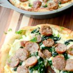 Sausage & Spinach White Deep Dish Pizza made with part skim Ricotta and Mozzarella cheeses, fresh spinach, garlic and sweet Italian sausage.