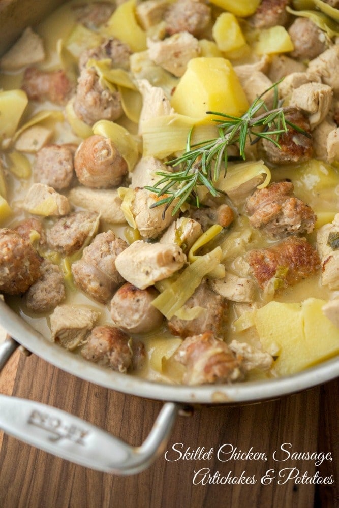 A close up of Skillet Chicken, sausage, artichokes and potatoes