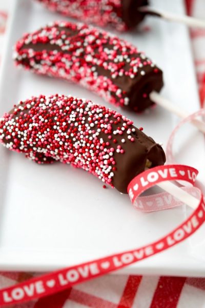 A close up of valentines banana pops on a plate