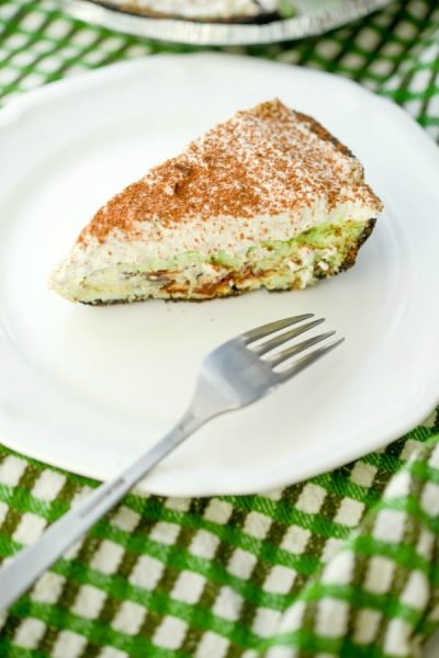 Chocolate Chip Mint Pie made with cream cheese, condensed milk, dark chocolate and mint in an Oreo crust is perfect for your St. Patrick's Day celebrations!