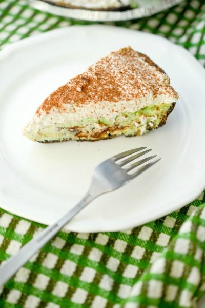 A piece of chocolate chip mint pie on a plate with a fork