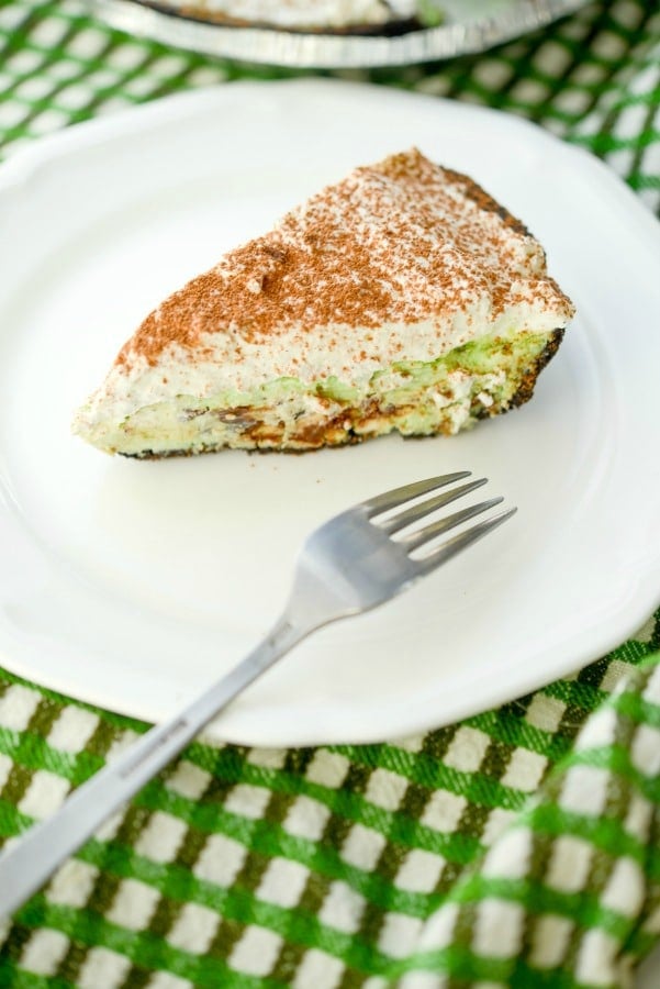 A piece of chocolate chip mint pie on a plate with a fork 