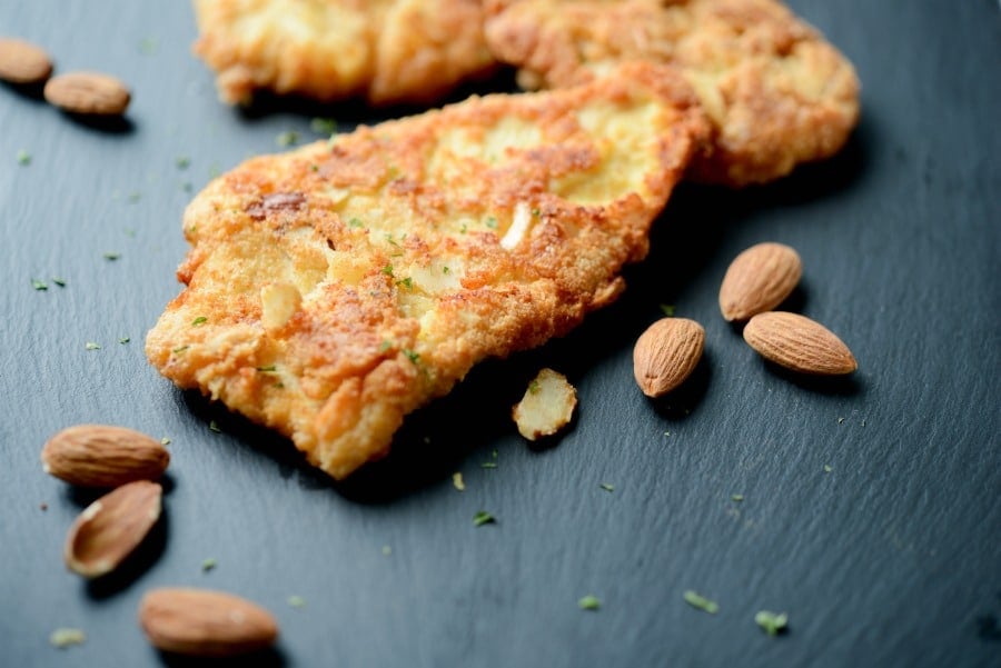 Almond Encrusted Chicken Cutlets on a cutting board