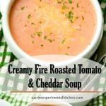 A bowl of Creamy Fire Roaster Tomato and Cheddar Soup on a table