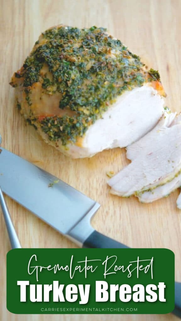 turkey breast with herbs on a wooden cutting board
