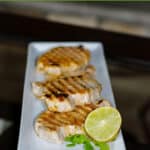 Grilled boneless, center cut pork chops marinated in a brine of fresh lime juice and cilantro; then grilled to perfection.