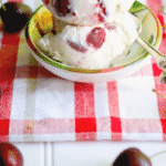 Cherry Vanilla Ice Cream in a dish with spoon and fresh cherries