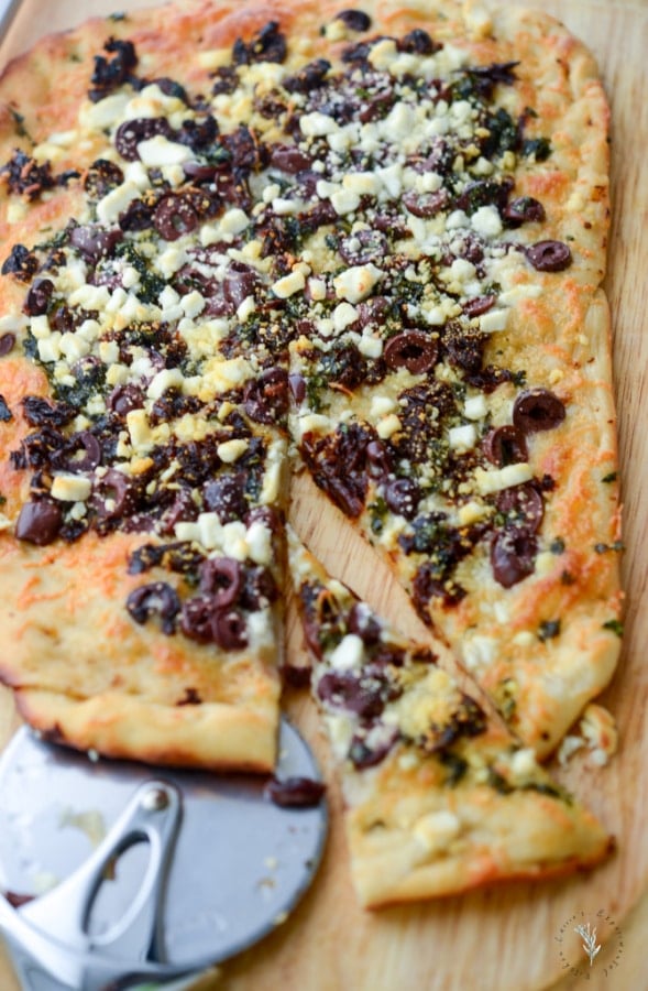 Thin crust flatbread topped with sun dried tomatoes, Kalamata olives, fresh basil, Mozzarella and Goat cheese is perfect as an appetizer or dinner.