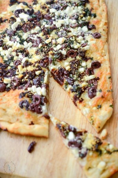 Thin crust flatbread topped with sun dried tomatoes, Kalamata olives, fresh basil, Mozzarella and Goat cheese is perfect as an appetizer or dinner.