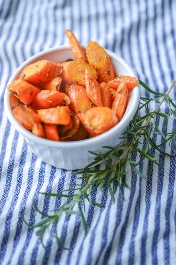 A bowl of Rosemary Roasted Carrots on a table