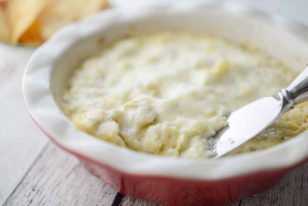 Marinated Hot Artichoke Dip with knife horizontal