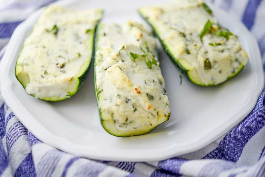 Ricotta, Goat Cheese and Basil Stuffed Zucchini Boats on plate