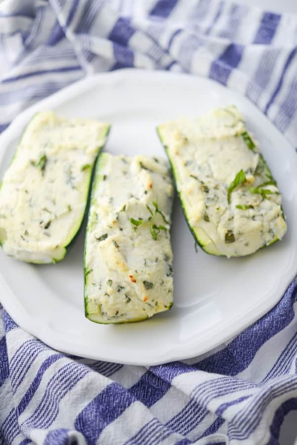 A plate of Ricotta, Goat Cheese and Basil stuffed Zucchini on a table