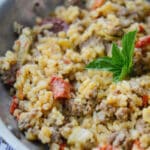 This risotto made with Italian sausage, artichoke hearts and sun dried tomatoes is deliciously flavorful and can be made in one skillet.