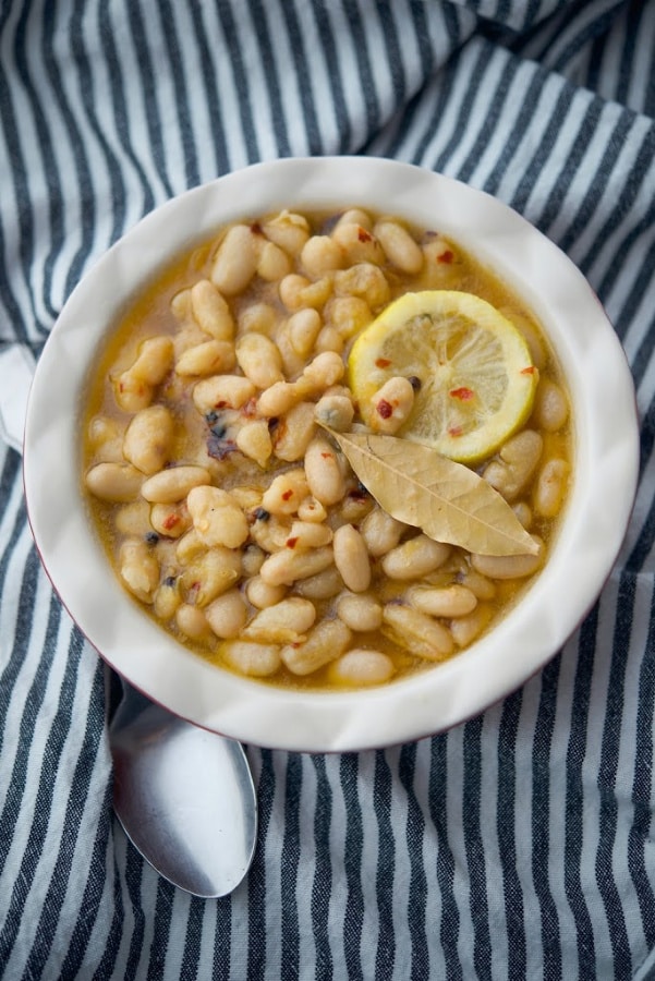 Cannellini beans marinated in EVOO, lemon slices and spices make a tasty, last minute healthy appetizer. A must have addition to any antipasto platter.