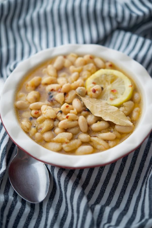A bowl of Marinated Cannellini Beans with a spoon 