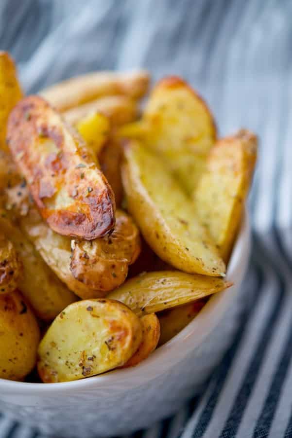 Fingerling potatoes tossed with EVOO, oregano and lemon juice; then roasted until crispy and golden brown make a deliciously tasty side dish. 