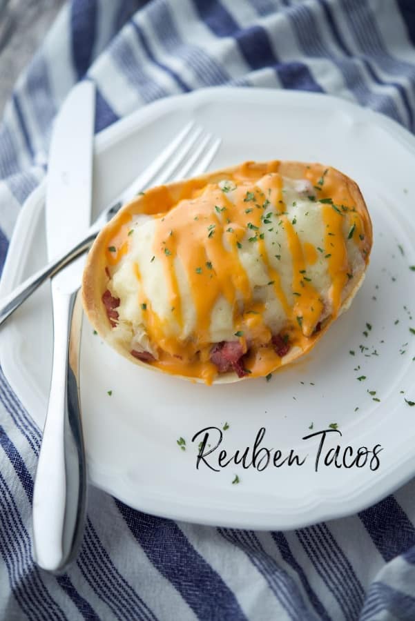 Reuben taco on a plate with fork and knife