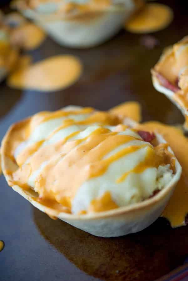 A close up of Reuben tacos on a tray