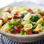 Tortellini Salad with Sun Dried Tomatoes and Broccoli in a white bowl