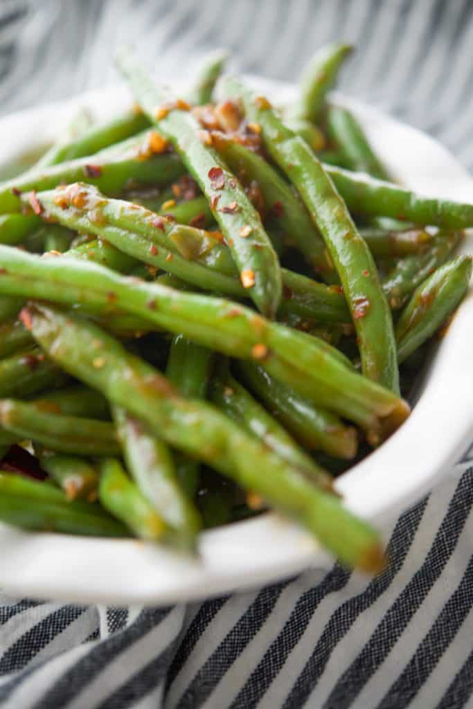 Chili Garlic Green Beans with an Asian flare are one of PF Changs most popular side dishes. Now you can make these tasty vegetables at home!